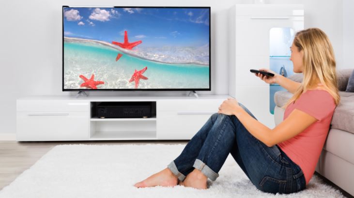 Girl watching TV in smart home